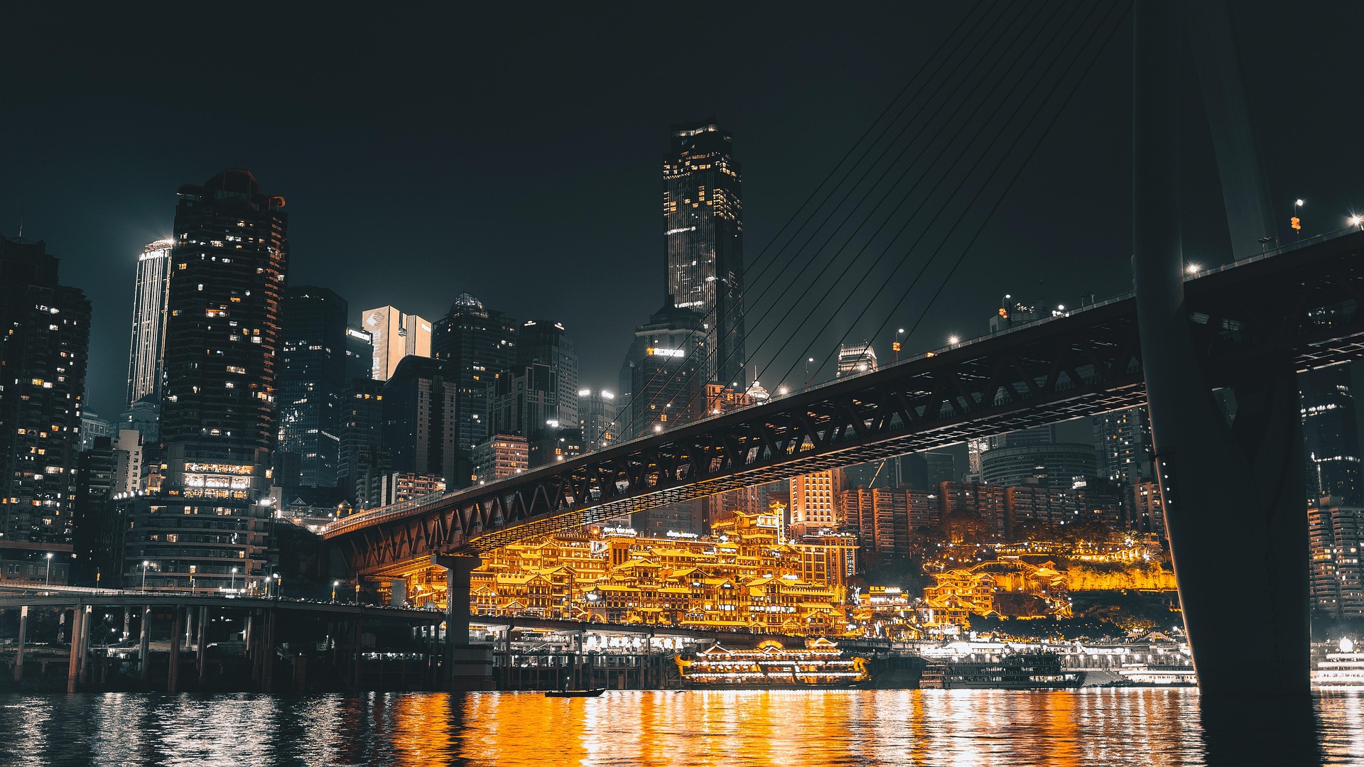 Stunning night view of Hongyadong (Hongya Cave) in Chongqing, China – illuminated traditional buildings, Yangtze River cruise, and modern skyline.