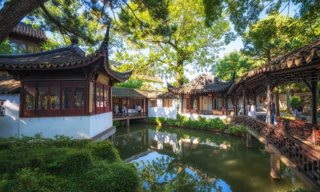 A classical garden scene at the Humble Administrator’s Garden in Suzhou, with traditional pavilions, water, and lush trees