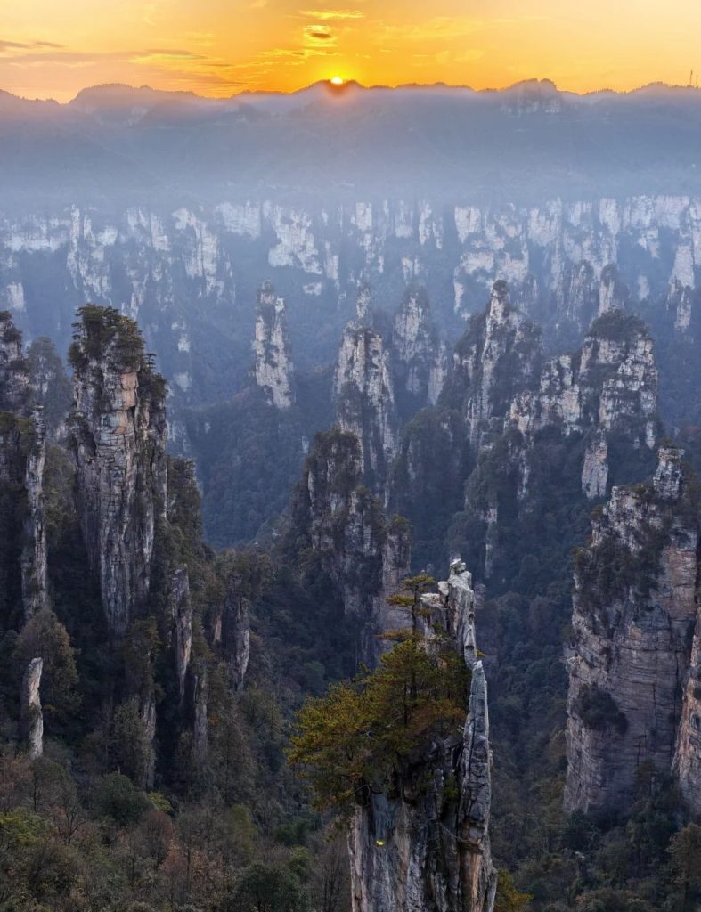 Zhangjiajie Sandstone Pillars at Sunrise Zhangjiajie sandstone pillars at sunrise in Wulingyuan, Hunan, China