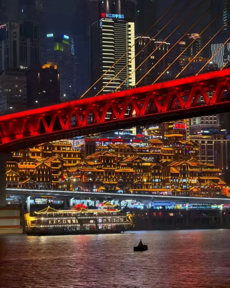 Hongya Cave illuminated beneath Qiansimen Bridge in Chongqing