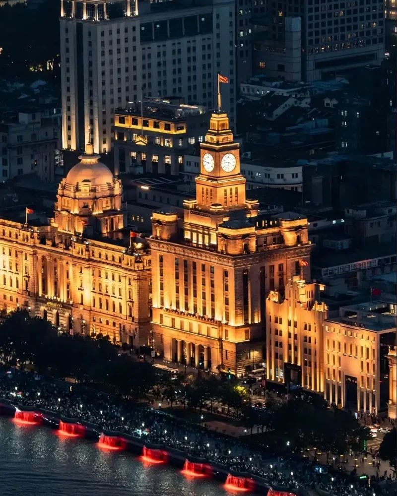 Historic Bund buildings illuminated beside the Huangpu River