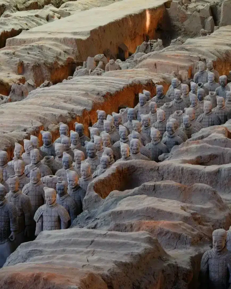 Rows of Terracotta Warriors standing in the excavated earth pits at the museum near Xi’an