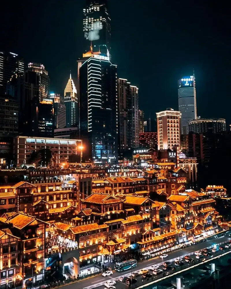 Hongya Cave’s riverside buildings illuminated at night in Chongqing