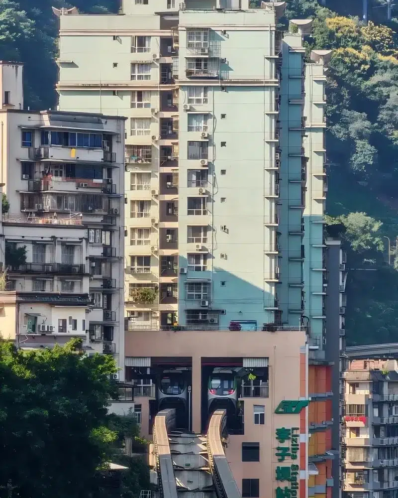 Train emerging through the Liziba building in Chongqing