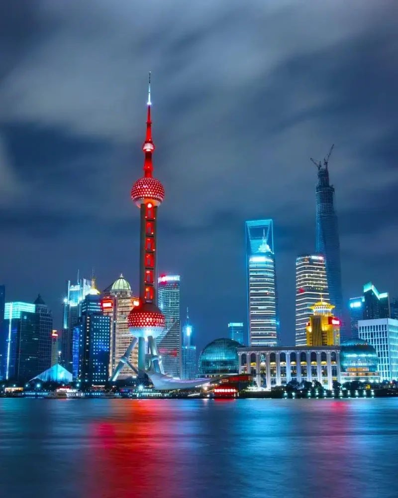 Pudong skyline illuminated across the Huangpu River in Shanghai
