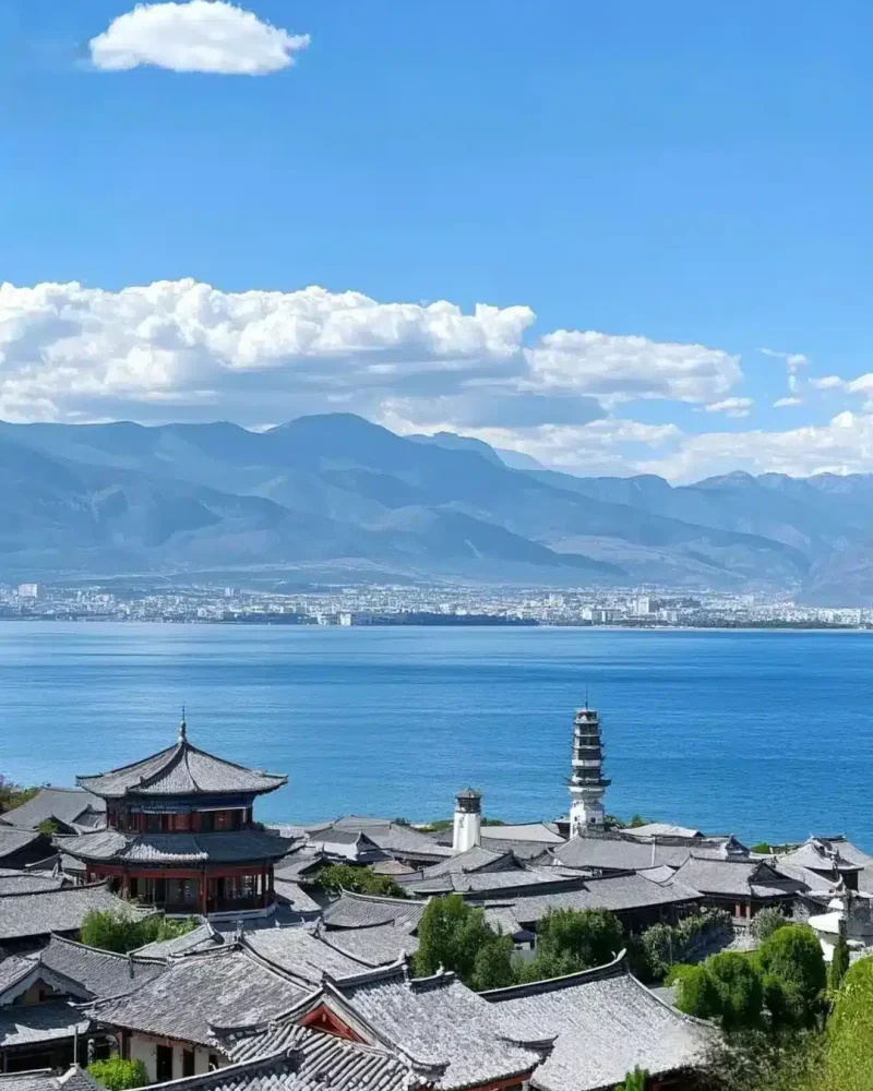 Rooftops beside Erhai Lake with mountains beyond, Dali