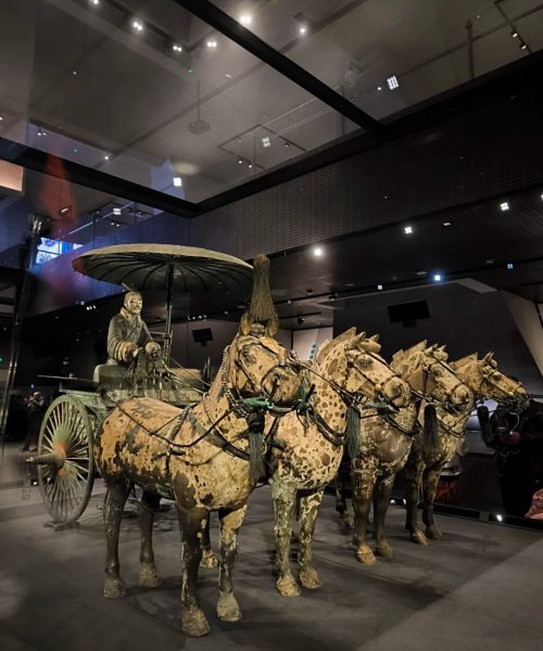 A full-scale bronze chariot with four horses from the Mausoleum of Qin Shi Huang, reflecting ancient China's advanced craftsmanship.