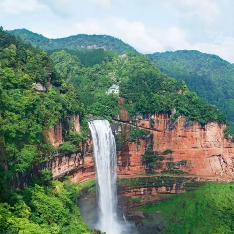 Shizhangdong Waterfall, Chishui Danxia Shizhangdong Waterfall in Chishui Danxia, Guizhou with red cliffs and forest
