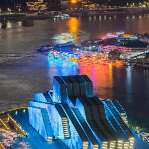 Night view of Chongqing Grand Theatre with city skyline and illuminated Yangtze and Jialing Rivers confluence