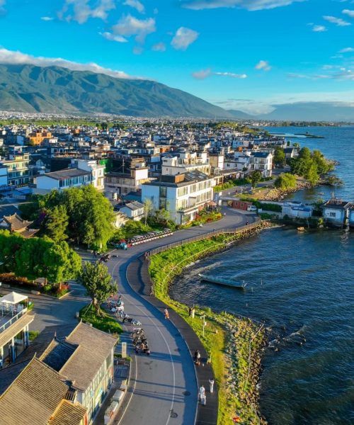 Scenic view of Erhai Lake with mountains and calm water from the roadside