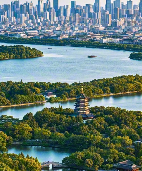 Aerial view of Leifeng Pagoda by West Lake with Hangzhou city skyline in the background.
