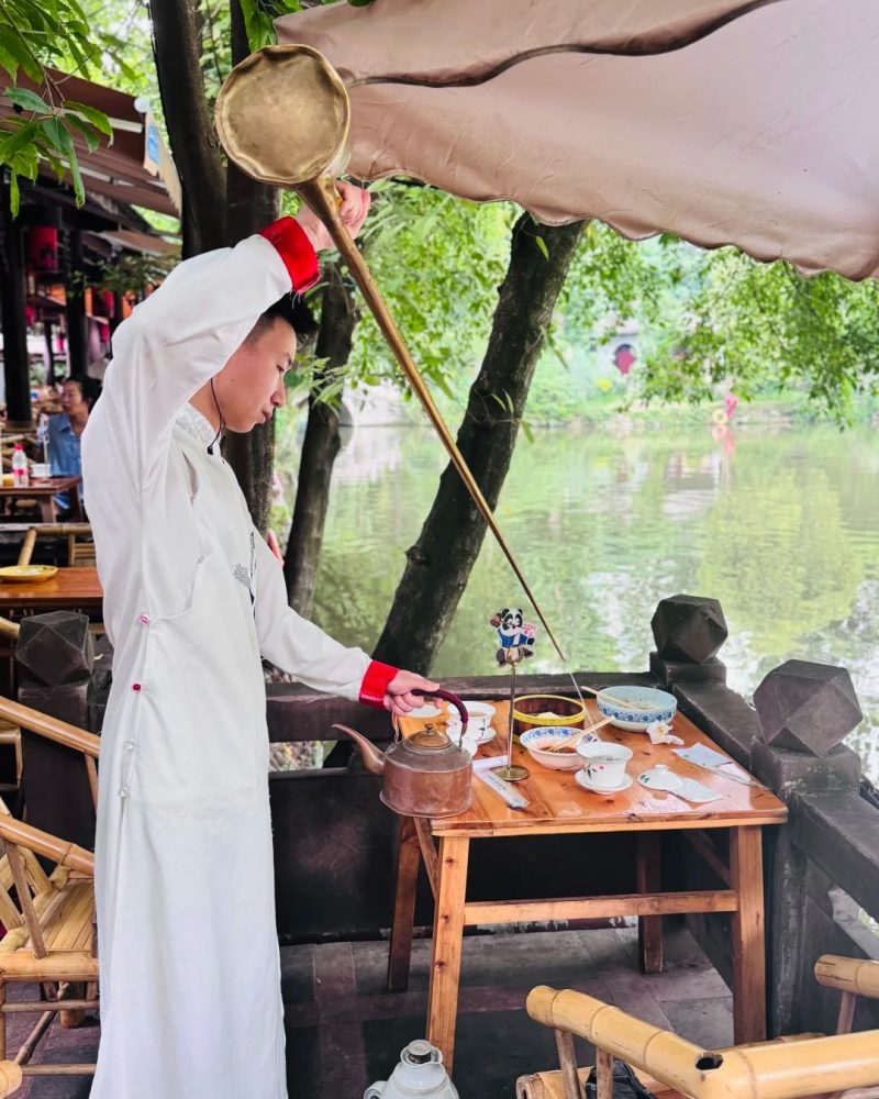 Tea being poured with a long-spout kettle at Heming Teahouse in People’s Park, Chengdu.