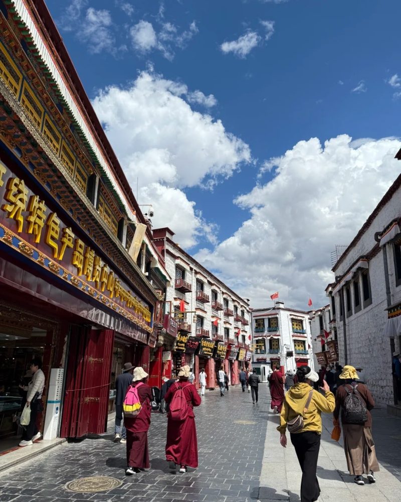 Monks and visitors walking along Barkhor Street in old Lhasa, Tibet
