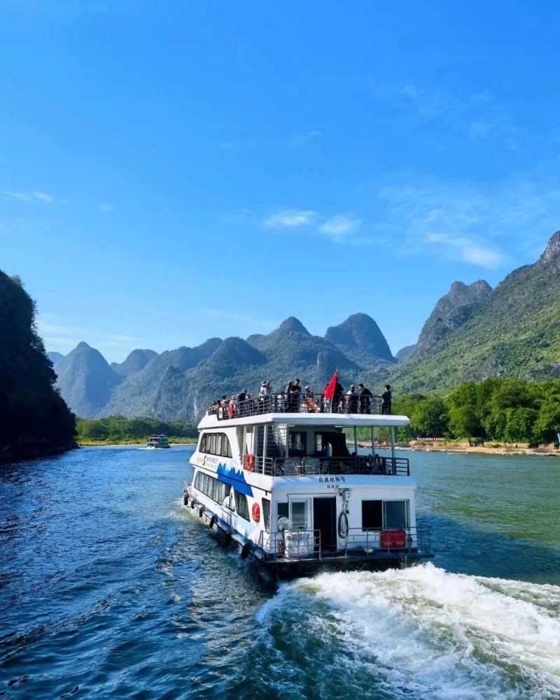 Li River cruise boat sailing between Guilin and Yangshuo with karst mountains