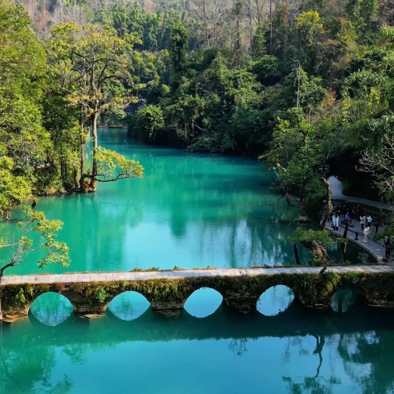 Libo Xiaoqikong, Guizhou Xiaoqikong in Libo, Guizhou with turquoise water and old stone bridge