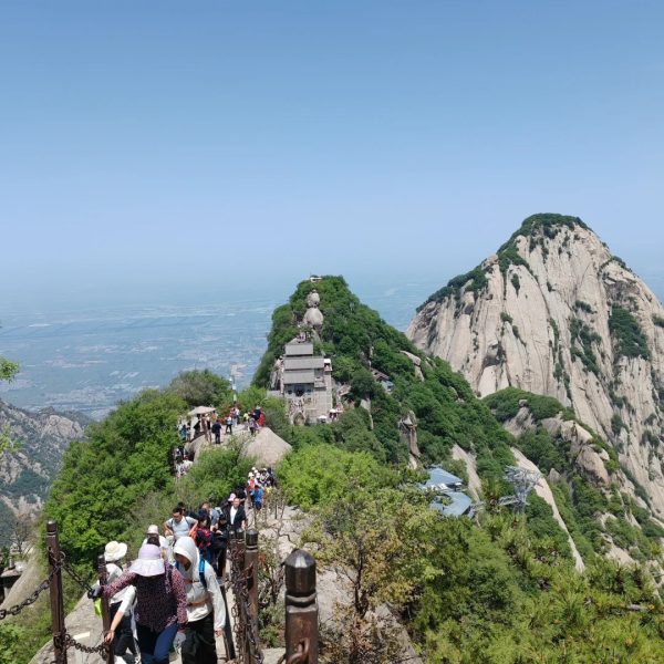 Tourists hiking the scenic trail on Mount Huashan, a famous mountain near Xi’an known for its steep cliffs, cultural significance, and breathtaking views.