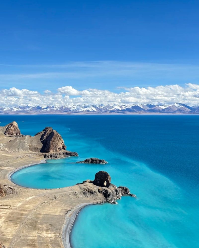 Namtso Lake in Tibet with expansive blue water and distant snow mountains