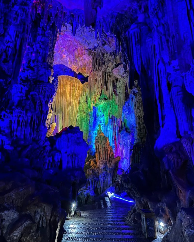 Color-lit limestone formations inside Reed Flute Cave in Guilin