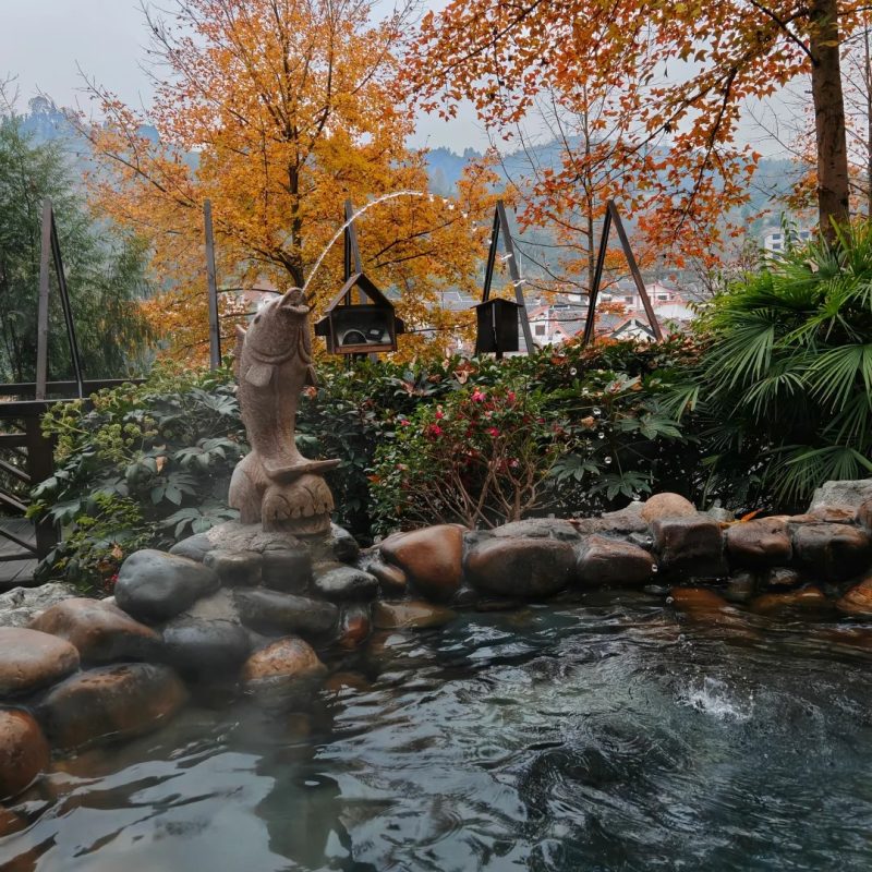 Shiqian Ancient Hot Springs, Guizhou Outdoor hot spring in Shiqian, Guizhou surrounded by trees and mountain scenery