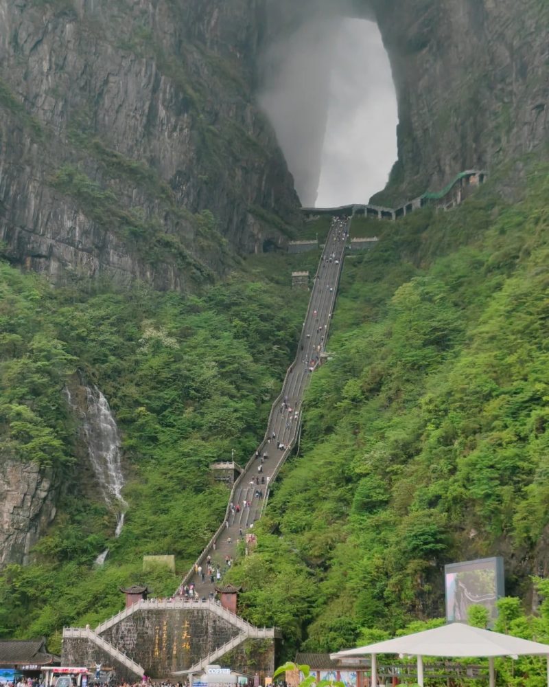 Tianmen Cave in Zhangjiajie, China, with the long stairway leading up through dramatic cliffs