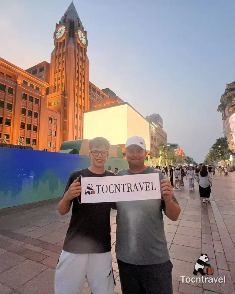 Two TOCNTRAVEL guests on Nanjing Road pedestrian street in Shanghai at dusk
