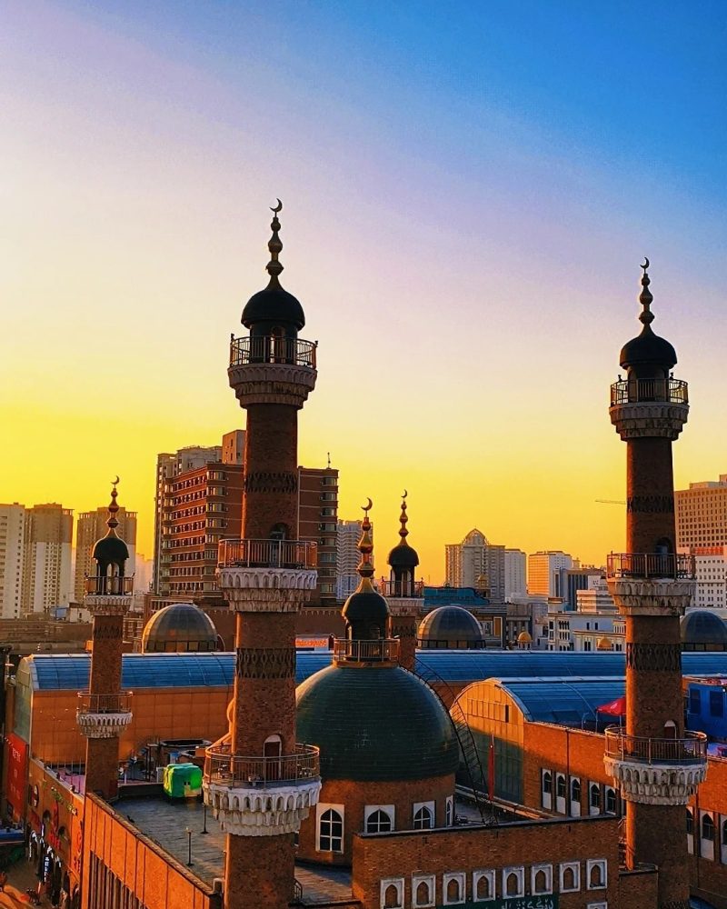 Traditional Islamic-style architecture against the sunset skyline of Urumqi, Xinjiang