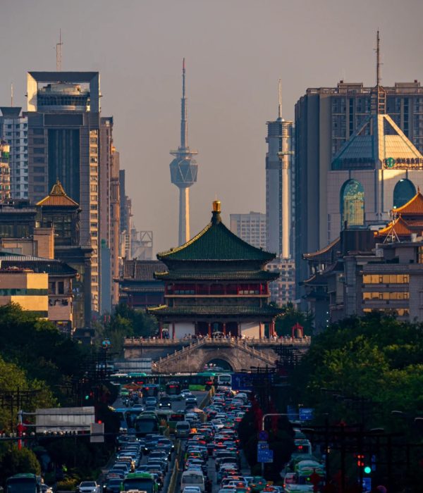 The Bell Tower of Xi’an standing amid modern skyscrapers and urban traffic, representing the fusion of ancient and modern China.