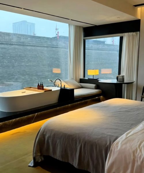 Unwind in a modern boutique hotel room that opens directly to the historic city wall of Xi’an. Featuring a minimalist design, a freestanding bathtub, and panoramic windows, this space offers a unique harmony of contemporary comfort and ancient history.