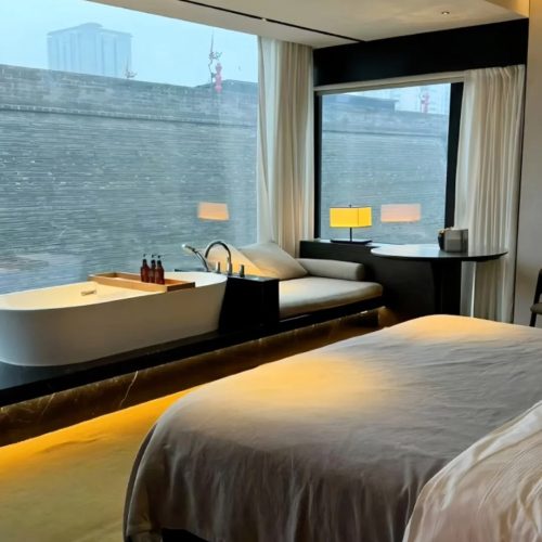Unwind in a modern boutique hotel room that opens directly to the historic city wall of Xi’an. Featuring a minimalist design, a freestanding bathtub, and panoramic windows, this space offers a unique harmony of contemporary comfort and ancient history.