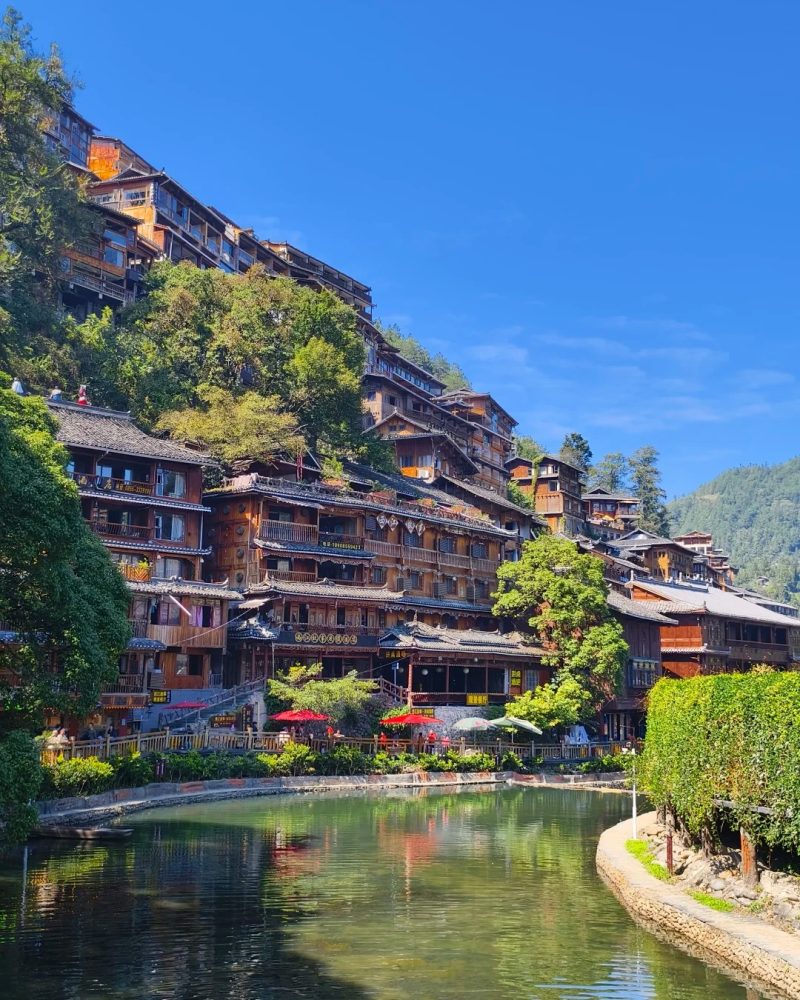 Wooden houses in Xijiang Miao Village during a Guizhou tour