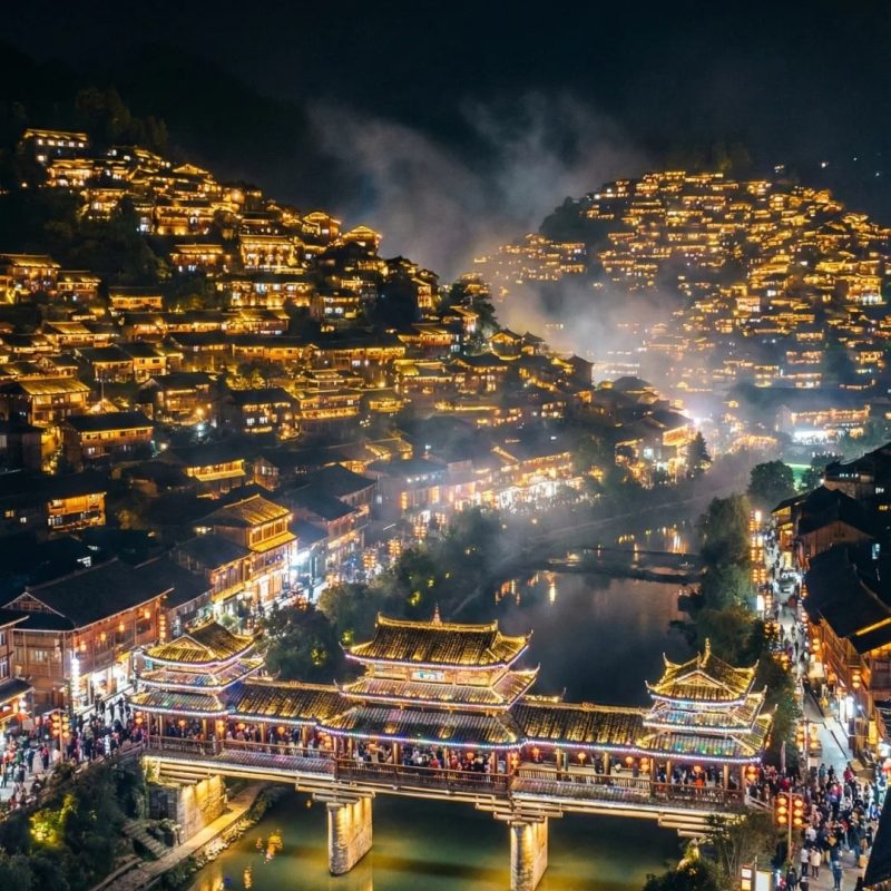 Xijiang Miao Village at Night, Guizhou Night view of Xijiang Miao Village in Guizhou with illuminated wooden houses