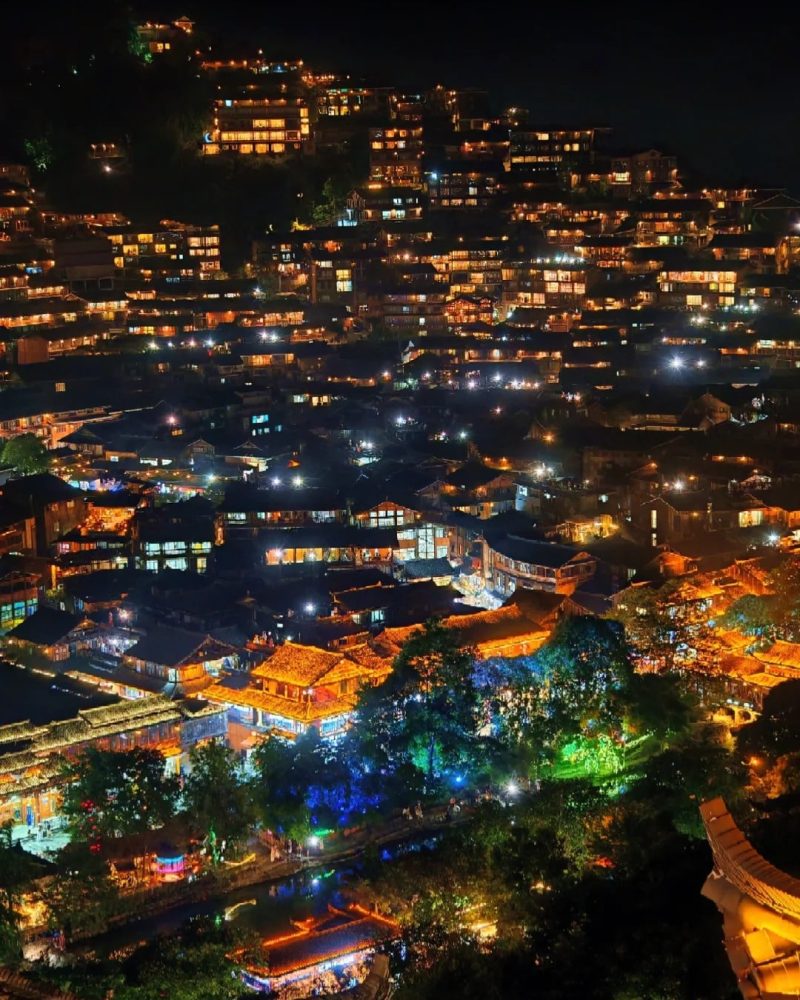 Xijiang Miao Village lit up at night in Guizhou