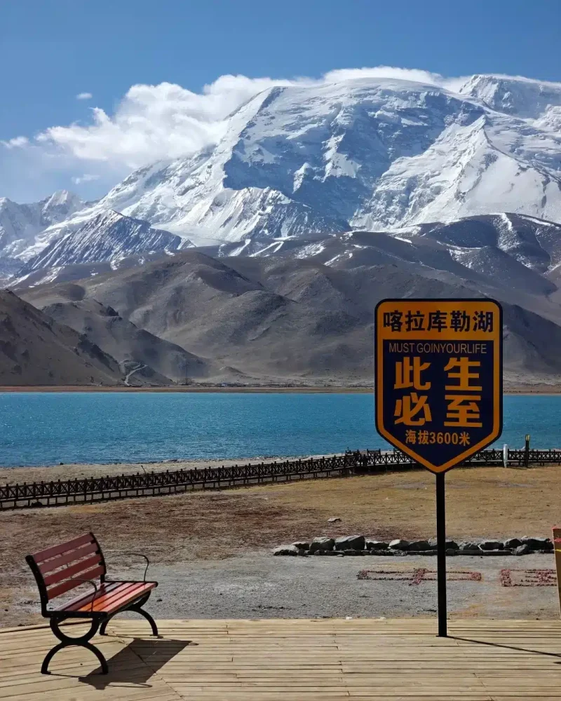 Karakul Lake beneath the snow-covered slopes of Muztagh Ata on the Pamir Plateau in Xinjiang.