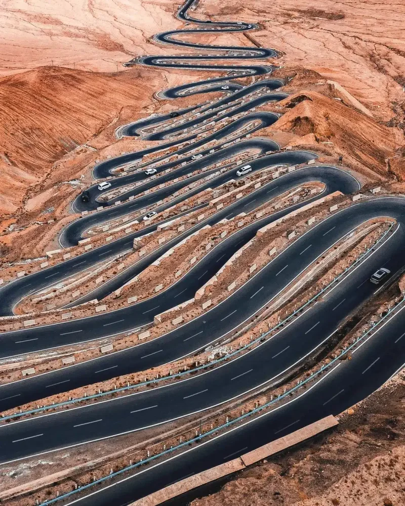 Aerial view of the tightly winding hairpin bends of Panlong Ancient Road near Tashkurgan, Xinjiang.