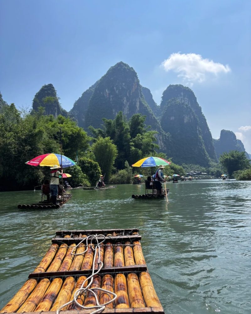 Bamboo rafting on the Yulong River in Yangshuo with karst peaks and calm water